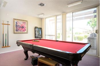 A games room with a pool table and a television